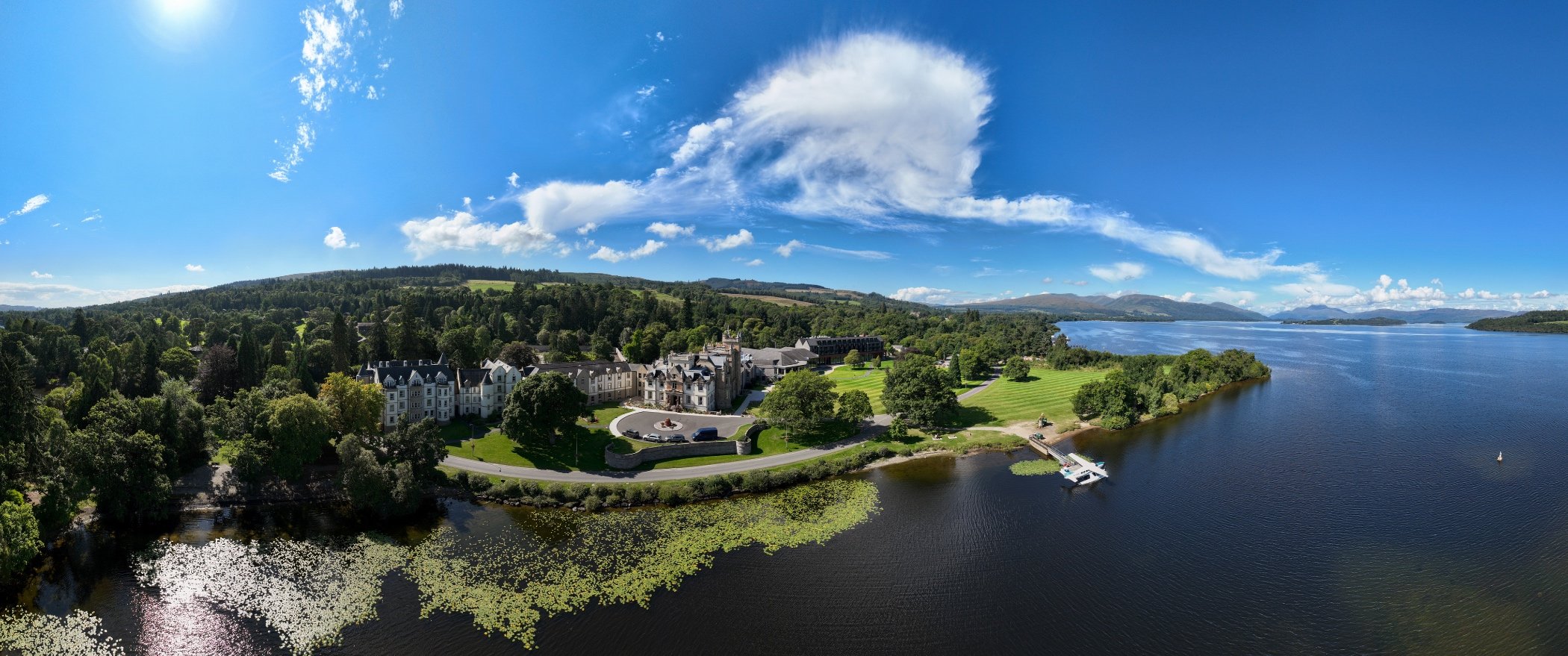 Aerial view of cameron house showing the beautiful green hotel grounds and the blue waters of Loch Lomond