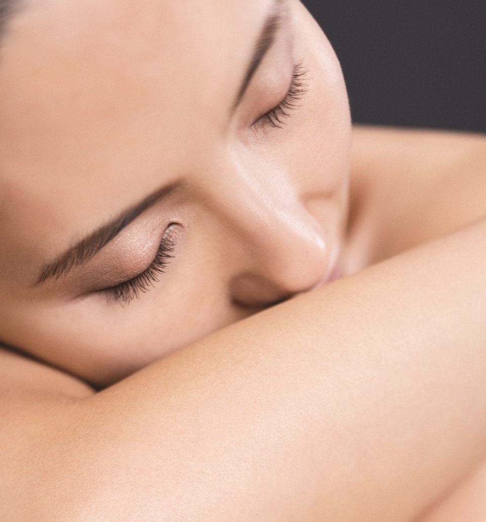 a close up of a woman laying on her arm looking to the side