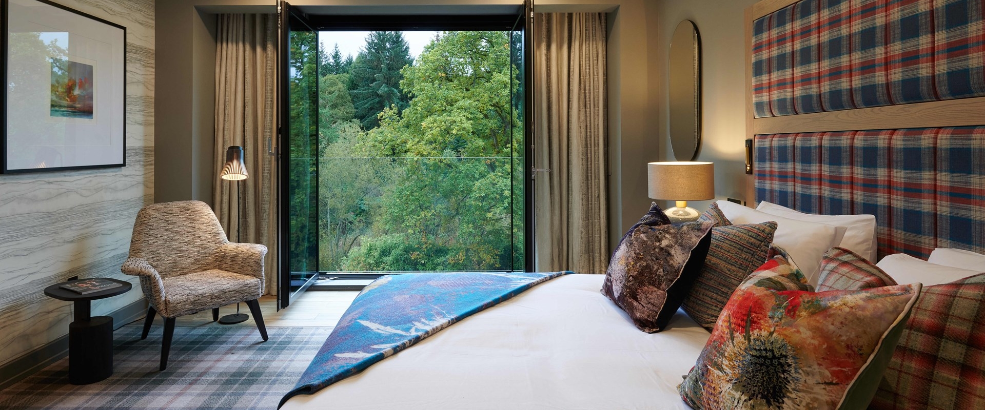 Spacious hotel room with a large window.