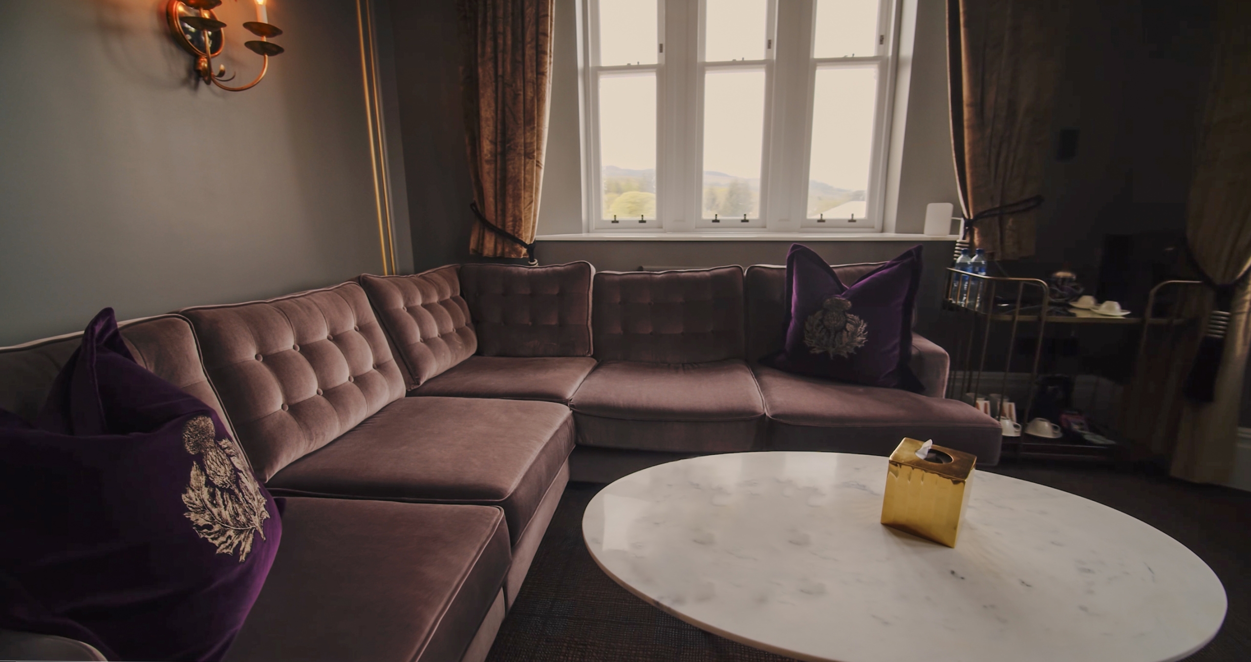 The seating area in the Tower Suite with a large sofa and white coffee table.