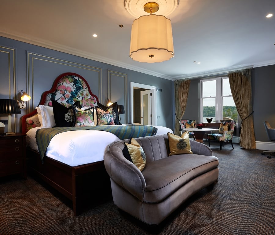 a large bed room with floral patterns on the head board of the bed