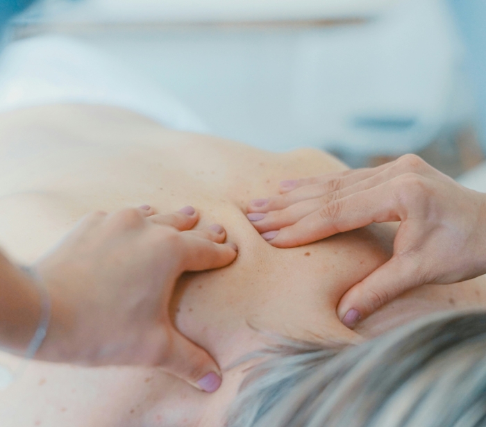 a person experiencing a deep tissue muscle massage while laying face down