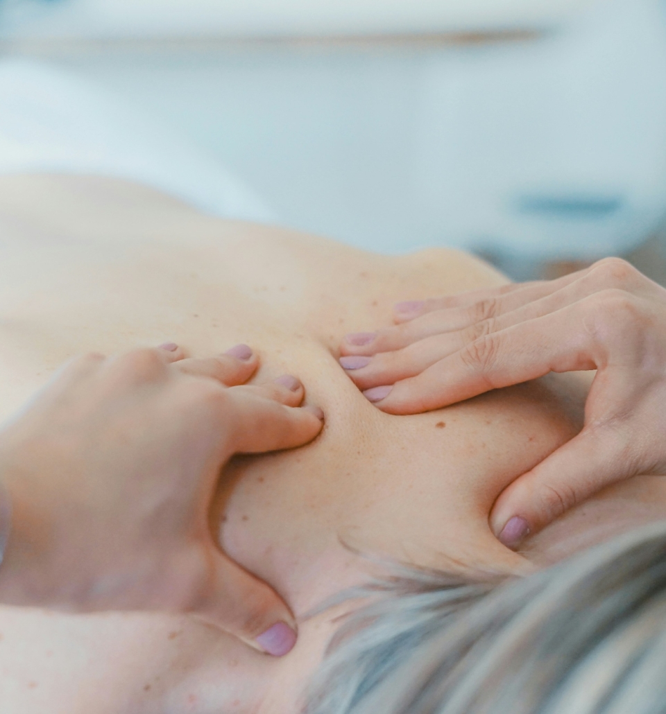 a person experiencing a deep tissue muscle massage while laying face down