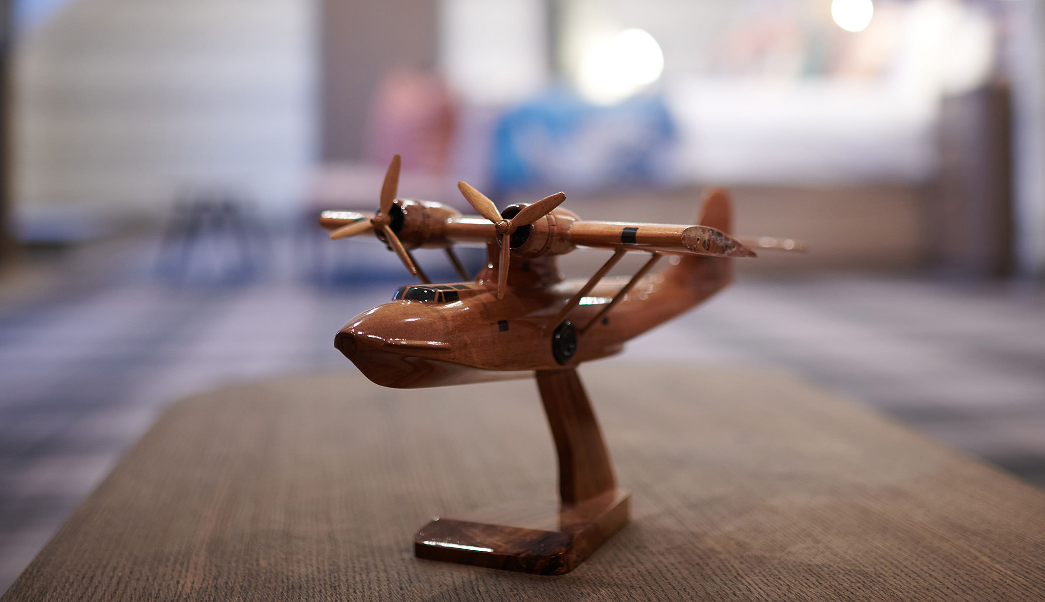 a close up view of a small wooden plane sitting on a table