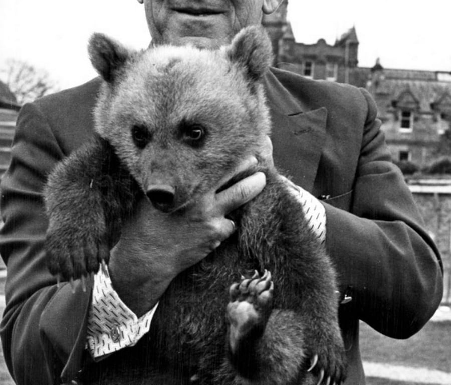 a man holding a small bear