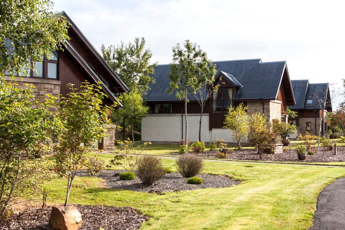 exterior view of lodges with trees in the front yard