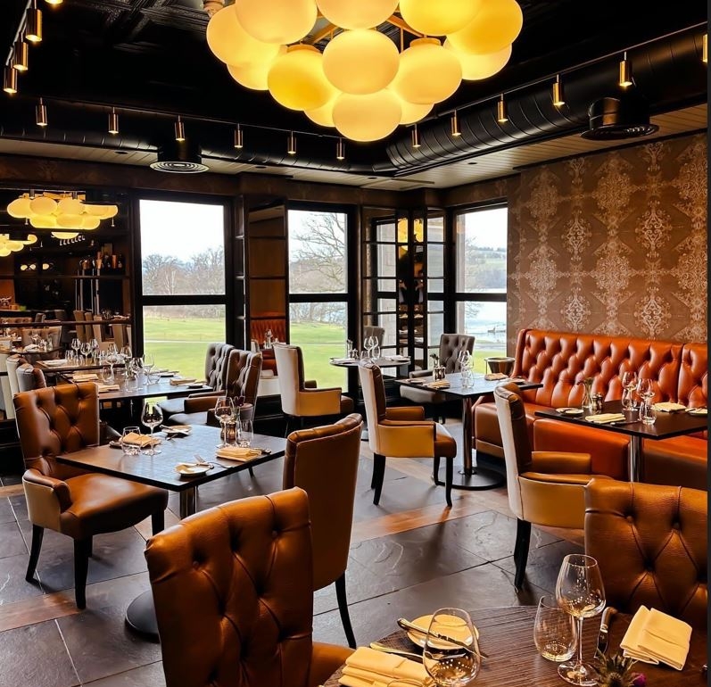 dining room with brown tables and chairs and bright lighting fixtures