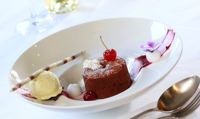 plate of pudding sitting in a bowl with lots of colors on the bowl