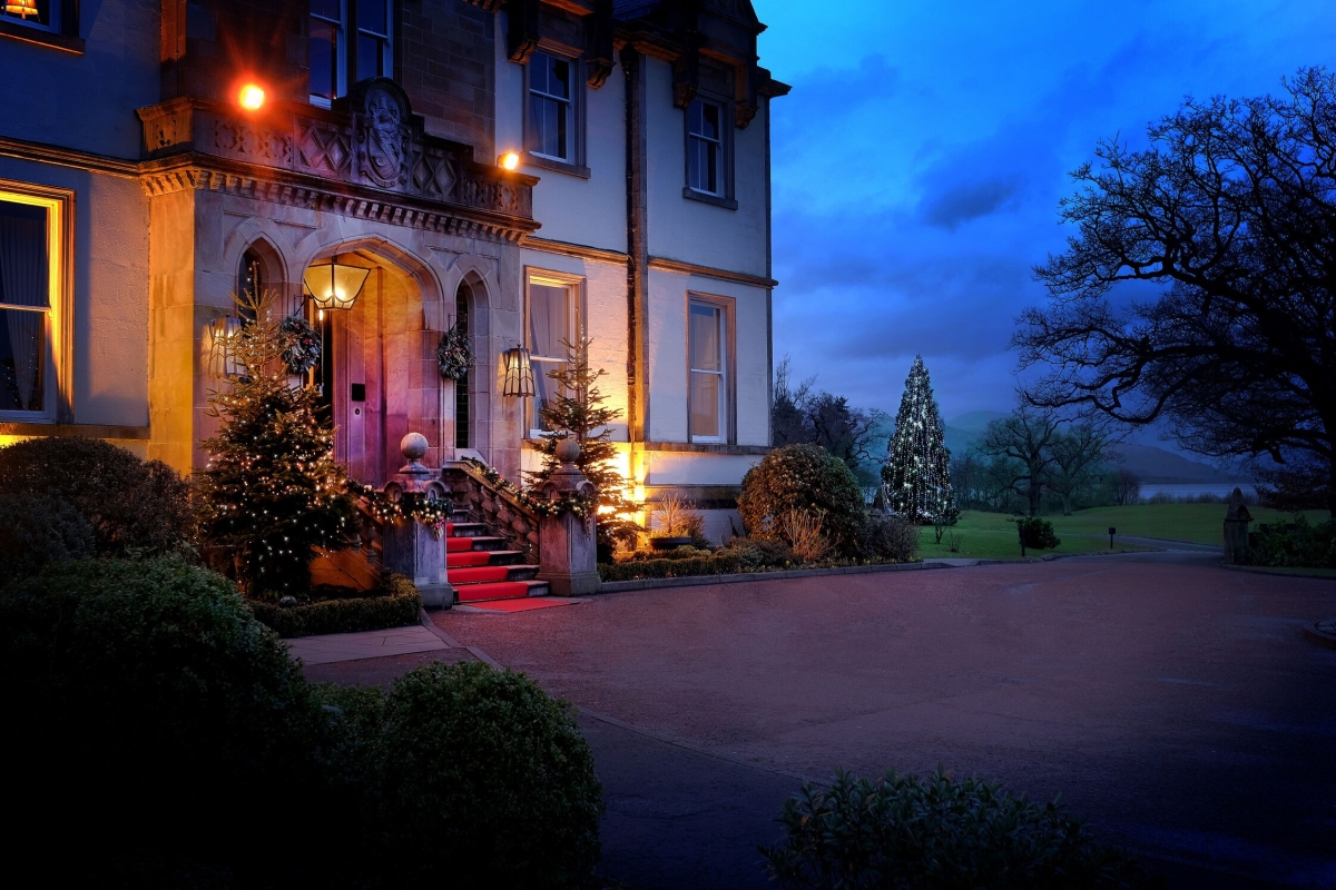 Exterior of Cameron House adorned with twinkling lights on the front steps, creating a festive ambiance for Christmas.