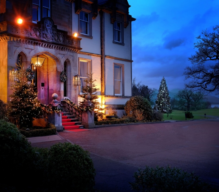 Exterior of Cameron House adorned with twinkling lights on the front steps, creating a festive ambiance for Christmas.