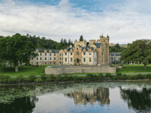 a large castle like building sitting on the edge of some water