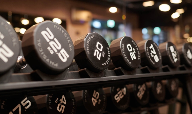 close up view of weights sitting on a rack in a gym