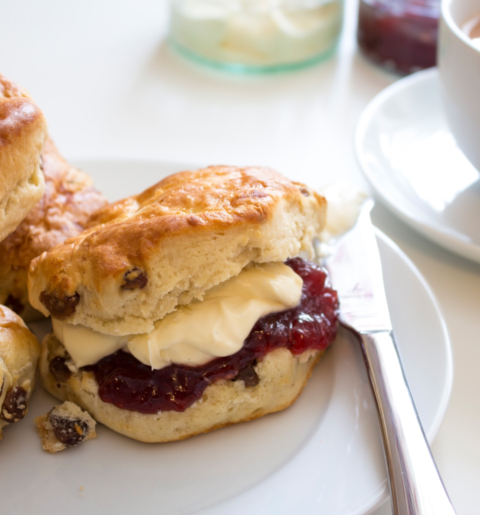 a plate full of scones covered in jam