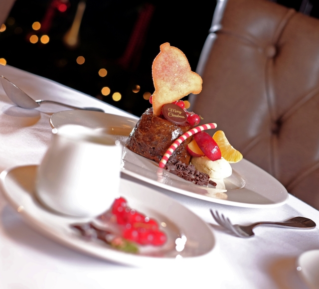 An exquisite Christmas dessert served on a plate and topped with fresh fruit, ready to be savored.