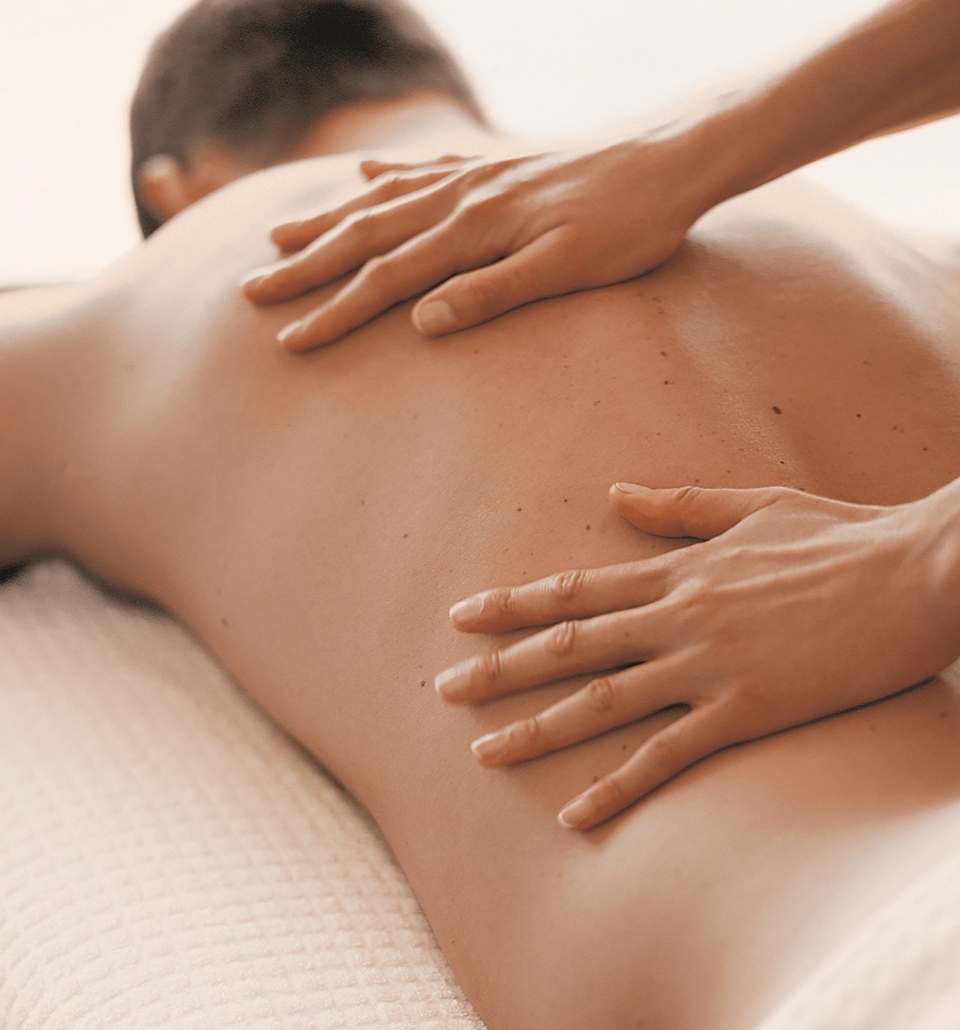 a male getting a back massage by a spa specialist