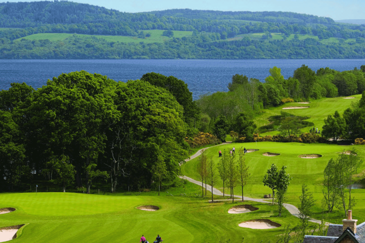 a over head view of a golf course with people playing golf below