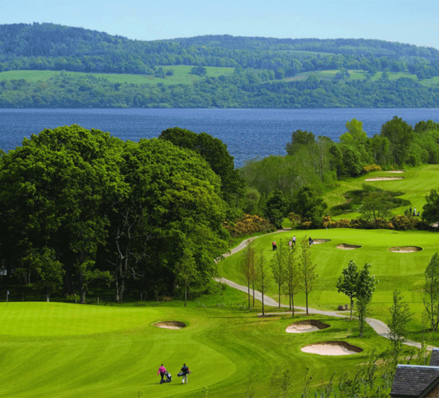 a over head view of a golf course with people playing golf below