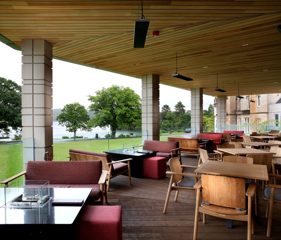 out door seating area with tables and chairs and great views of the water