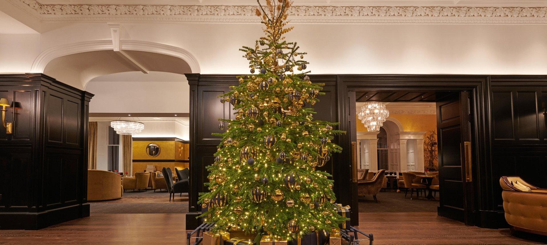 Festive Christmas tree adorned with colorful ornaments in the lobby of Cameron House.