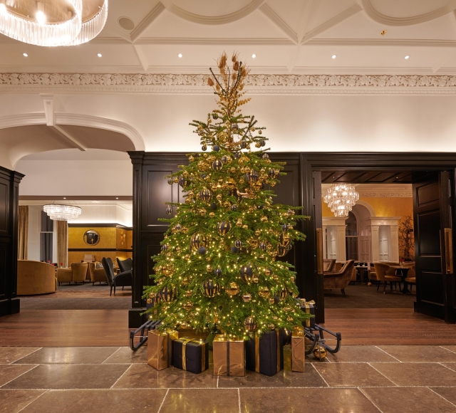 Festive Christmas tree adorned with colorful ornaments in the lobby of Cameron House.