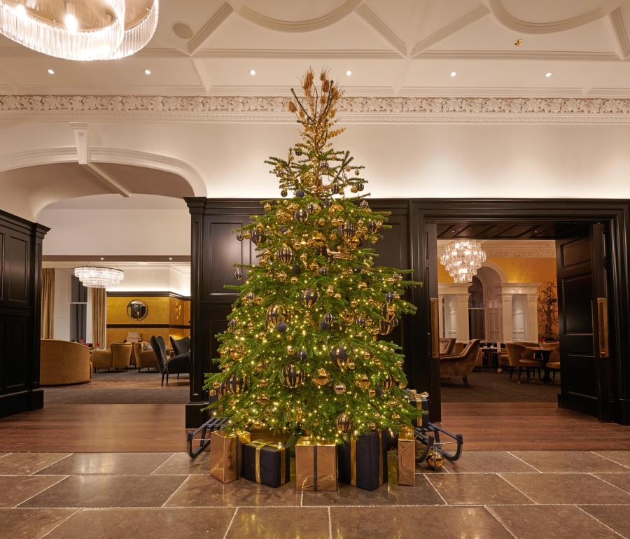 Festive Christmas tree adorned with colorful ornaments in the lobby of Cameron House.