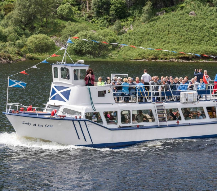 a group of people on a tour boat in the middle of the water