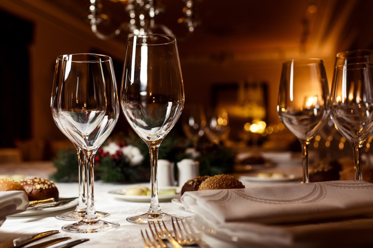 close up view of wine glasses on a table set up for dinner