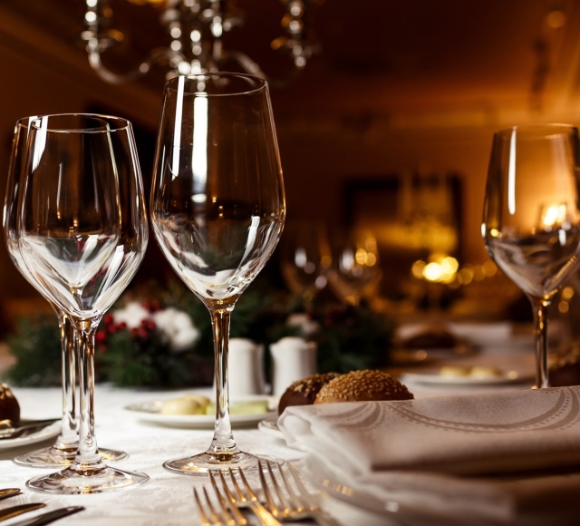 close up view of wine glasses on a table set up for dinner